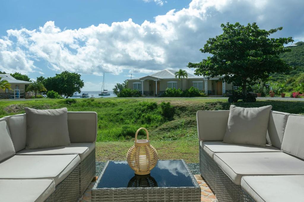 a living room with a couch and a vase on a table at Pirates Villa- Beach view with kayaks for Groups in Cruz Bay