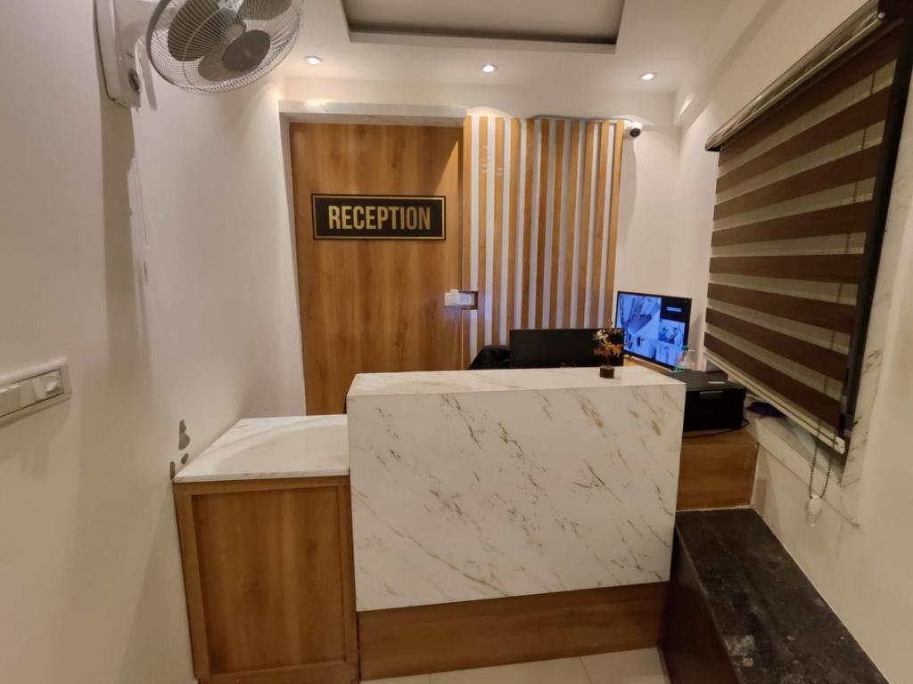 an office with a reception desk with a reception sign at Suites19 in Bengaluru