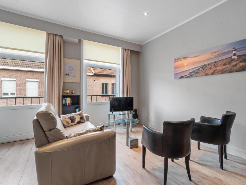 a living room with a couch and chairs at Ijzerstraat 52 - Vakantiewoning 52 in Blankenberge