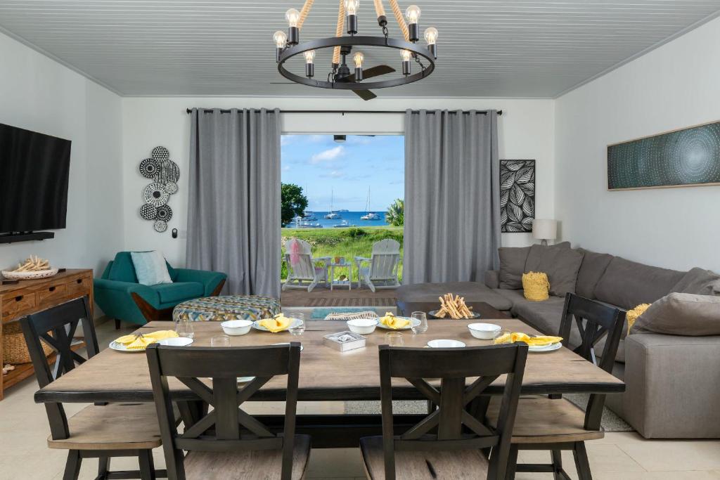 a living room with a table and a couch at Southern Star Villa Kayaks SUPS Steps to Beach in Monte
