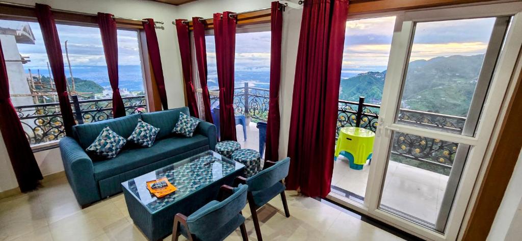 a living room with a couch and a balcony at Opal Villas Mussoorie near Mall Road in Mussoorie