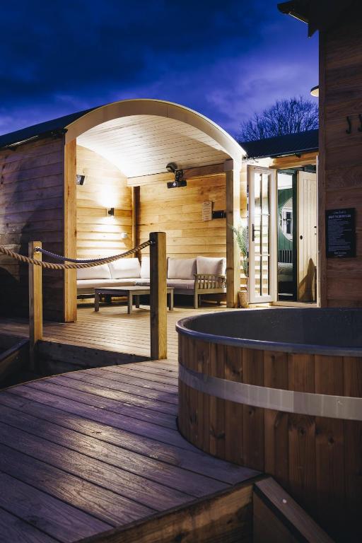 a wooden deck with a sauna with a bench at Nestledstays - The Oak in Walberton