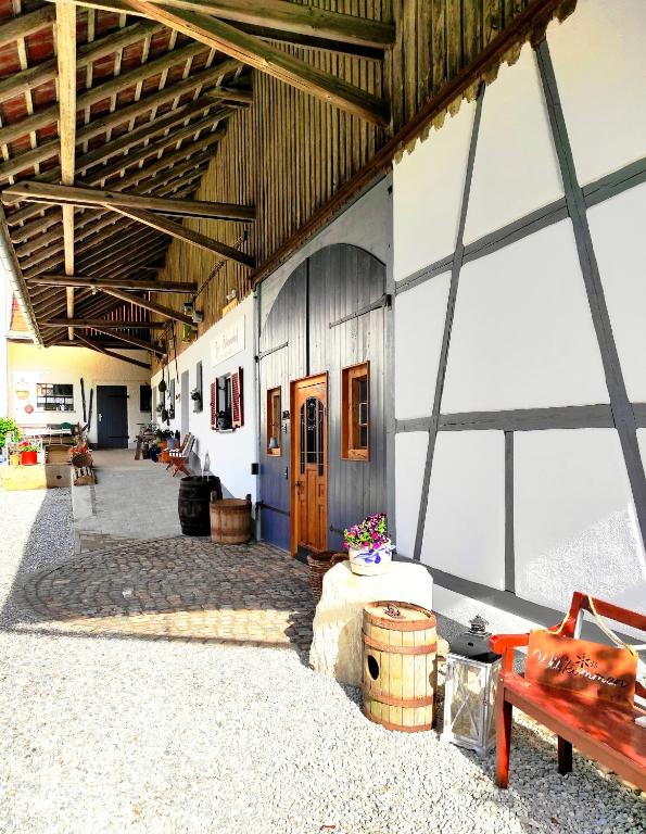 a large building with a room with a wooden door at ZUM SCHEUNENHOF- SCHEUNE - Nähe Legoland - Familienfreundlich - Handwerker willkommen in Ichenhausen