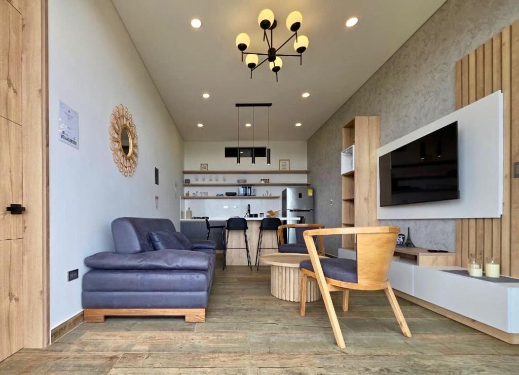 a living room with a couch and a dining room at Montecielo Hosting in Guatapé