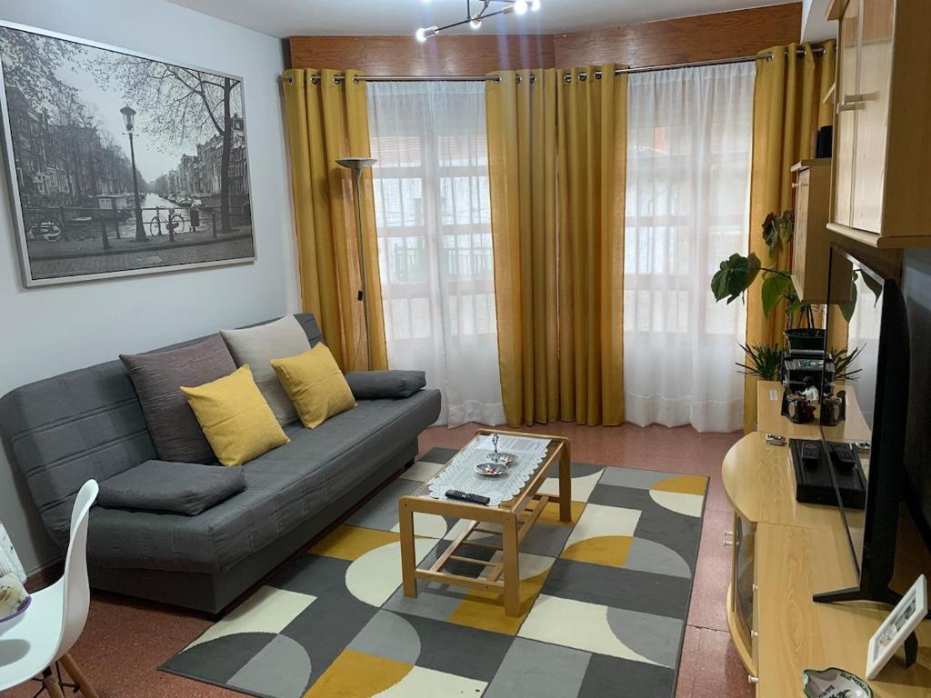 a living room with a couch and a table at La casita de Lukas in Sabero