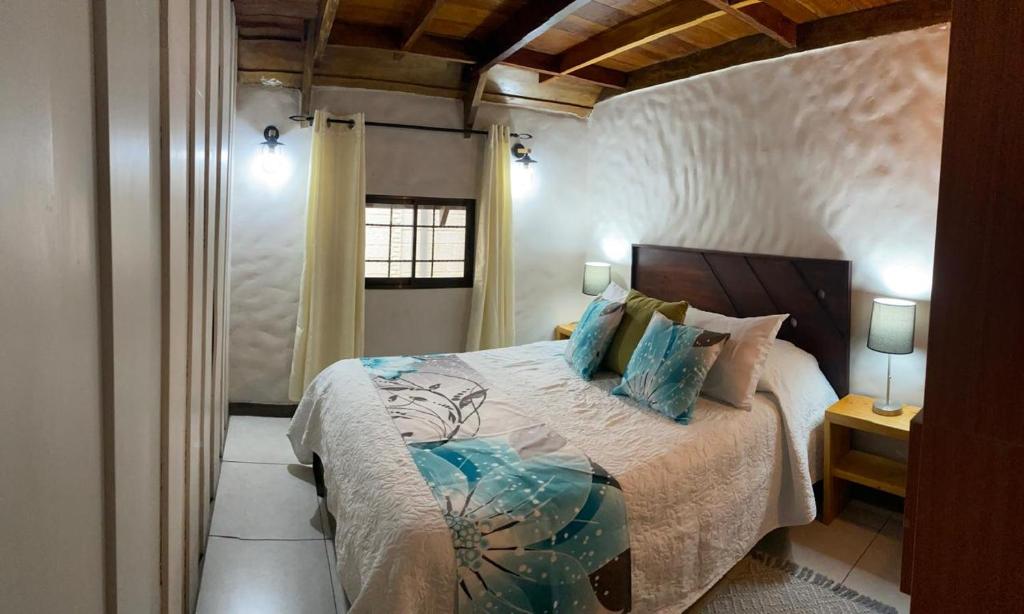 a bedroom with a large bed in a room at Cabaña de Montaña Flaki's in Monteverde Costa Rica