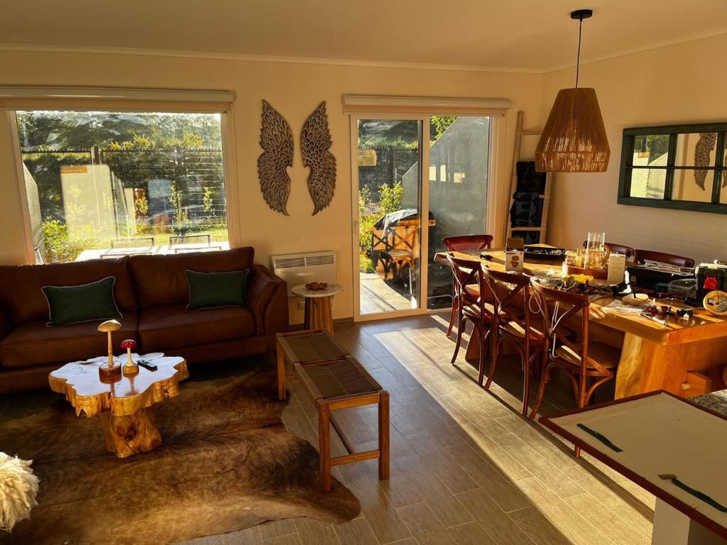 a living room with a couch and a table at Vive Pucón in Pucón