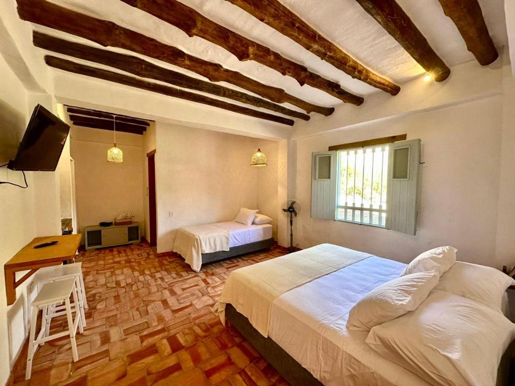 Ένα ή περισσότερα κρεβάτια σε δωμάτιο στο Casa Mónica Barichara