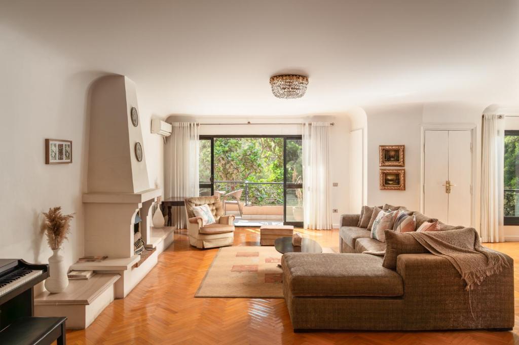 a living room with a couch and a fireplace at The White Coconut Stay in Cairo