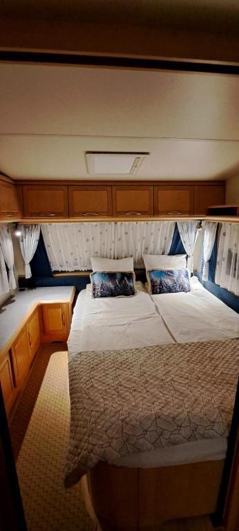 a bedroom with a large bed on a boat at Proboost Arctic Center Cosy Caravan in Rovaniemi