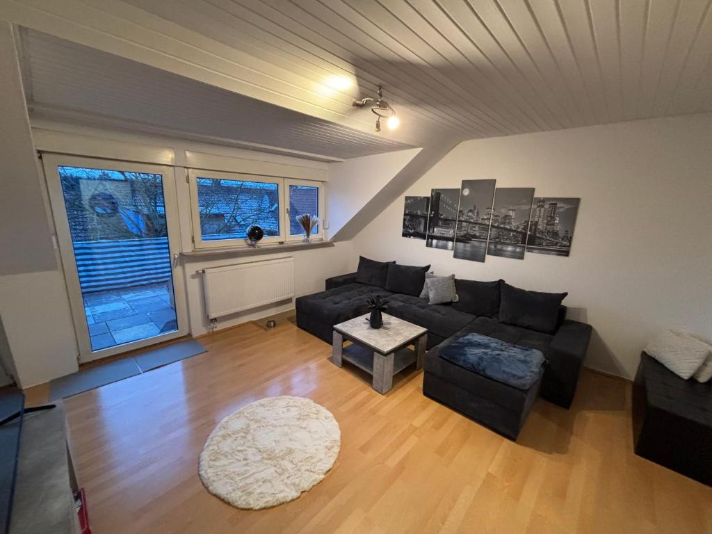 a living room with a couch and a table at Wohnung in Würzburg Rimpar I Netflix & TV I Kaffee I Tee I Brettspiele in Rimpar