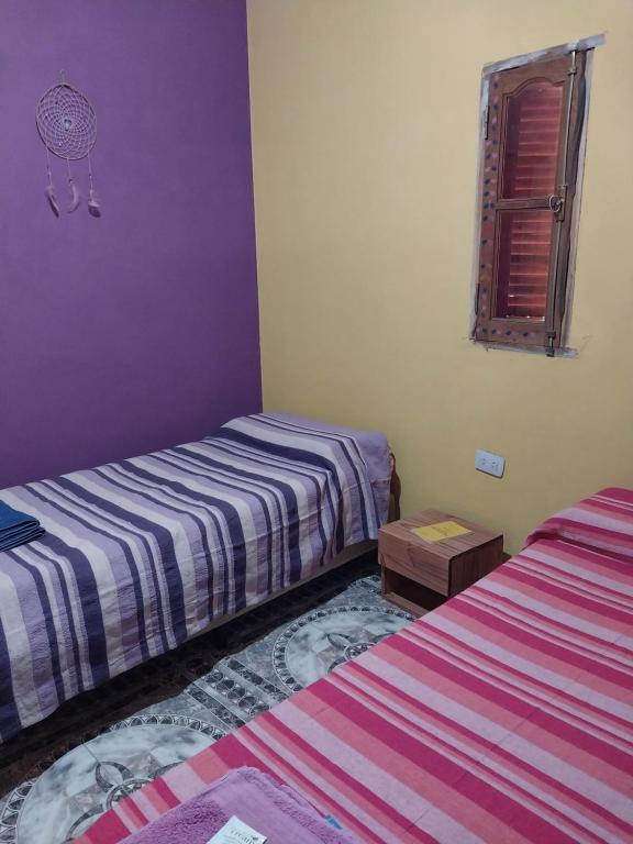 En eller flere senge i et værelse på Hostel Portal del Sol