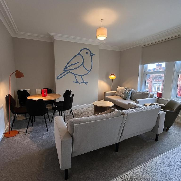 a living room with a couch and a table at The Bluebird Rooms III in Central Station