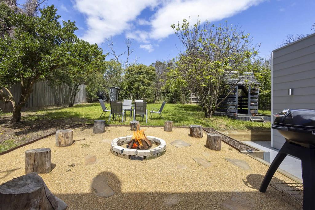 a backyard with a fire pit and a grill at Peaceful 2-Bed Apartment in Coastal McCrae in McCrae