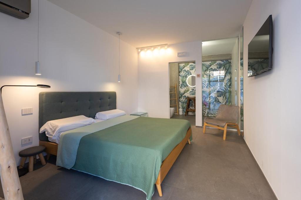 a bedroom with a large bed and a mirror at Tropicana Suite - Adults Only in Agropoli