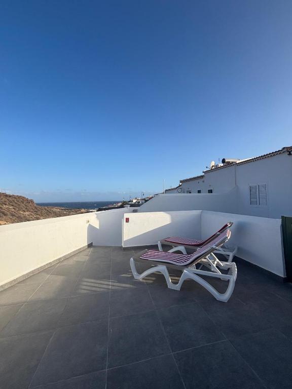 a couple of chairs sitting on top of a roof at Vidamar in Abades
