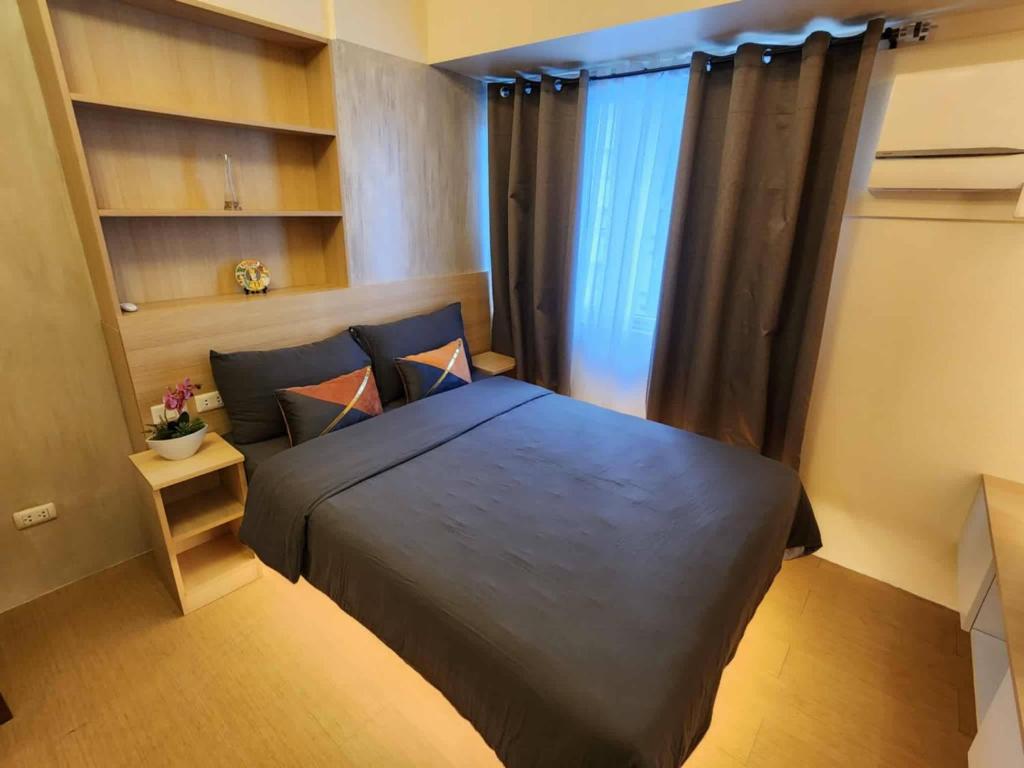 Una cama o camas en una habitación de Avida Tower 1