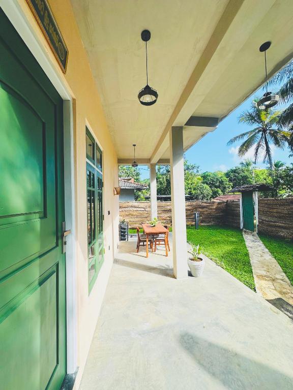 a front door of a house with a table at Villa Vows in Tangalle