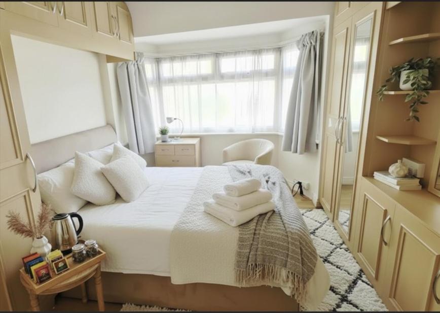 une chambre avec un lit avec des serviettes dessus dans l'établissement The Bliss House Peaceful Retreat Close Transport Links Central London in 15mins Close to Heathrow Airport, à Harrow on the Hill