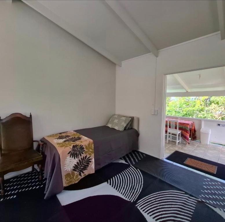 Postel nebo postele na pokoji v ubytování Raro Palms