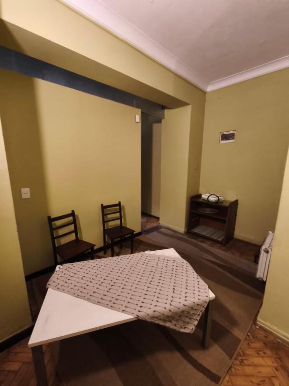 a room with a bed and two chairs and a table at Libertador 7 MVD in Montevideo