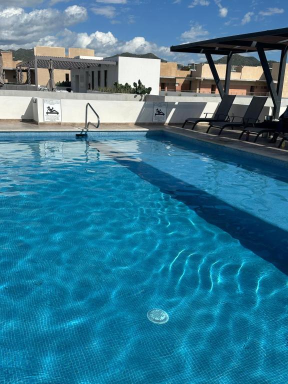 a swimming pool with blue water on top of a building at Hello Sunshine! in Cabo San Lucas