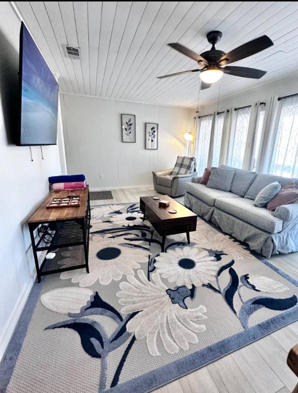 a living room with a couch and a table at Sunlit Sands Destin Condo in Destin