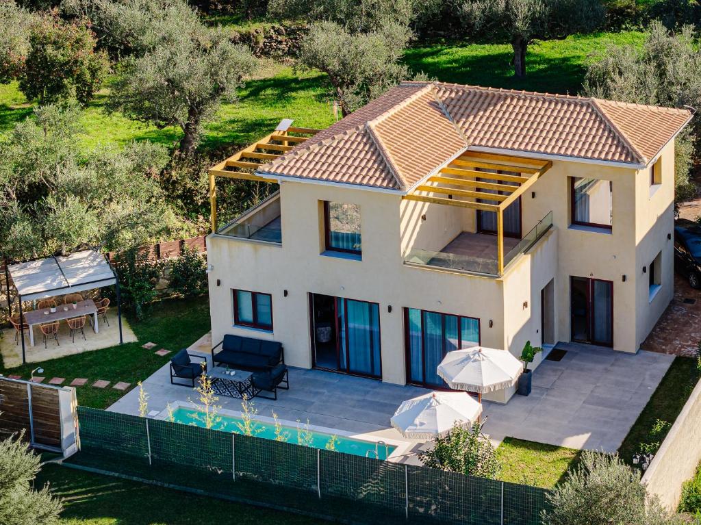 an aerial view of a house with a swimming pool at Adelda Villa in Kypseli