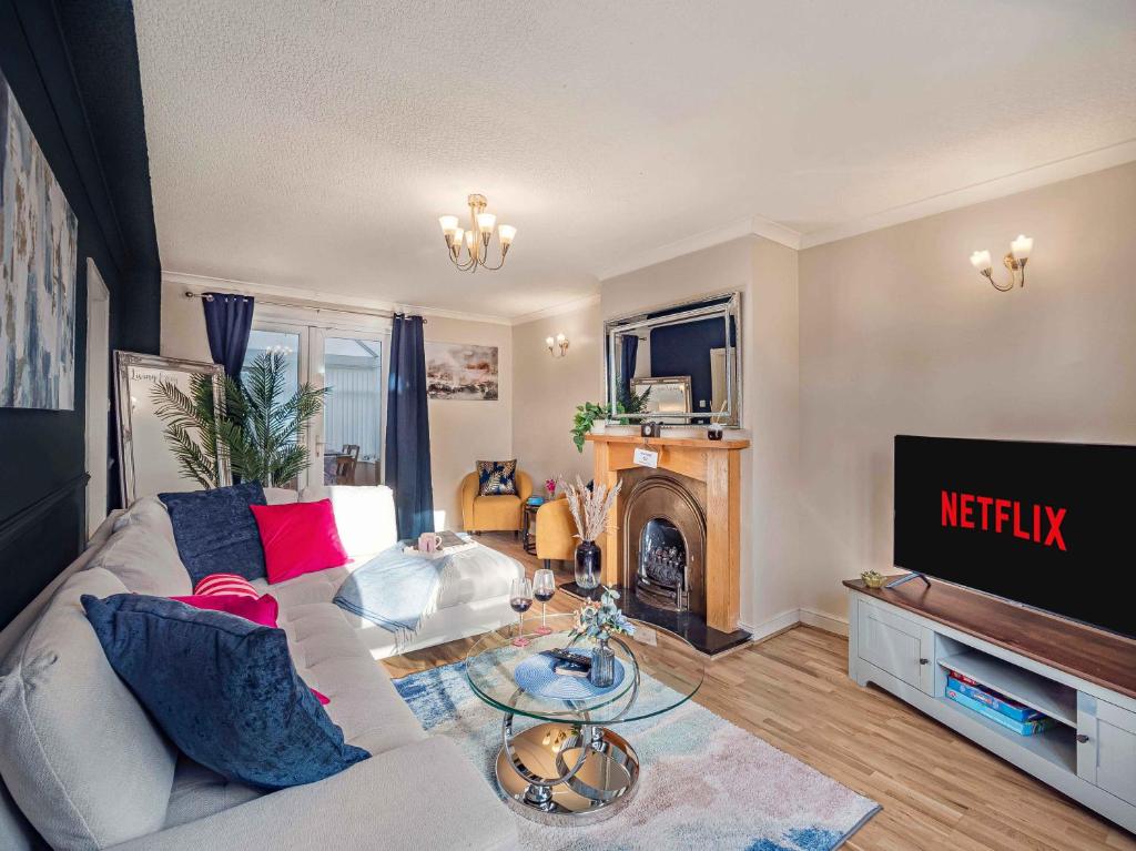 a living room with a couch and a fire place at Contractor ready Homes Secure Parking in Middleton