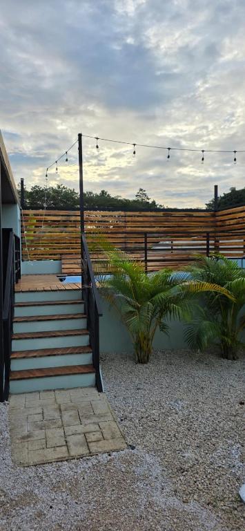 a set of stairs with a wooden fence and a fence at Live bambu in Caimital