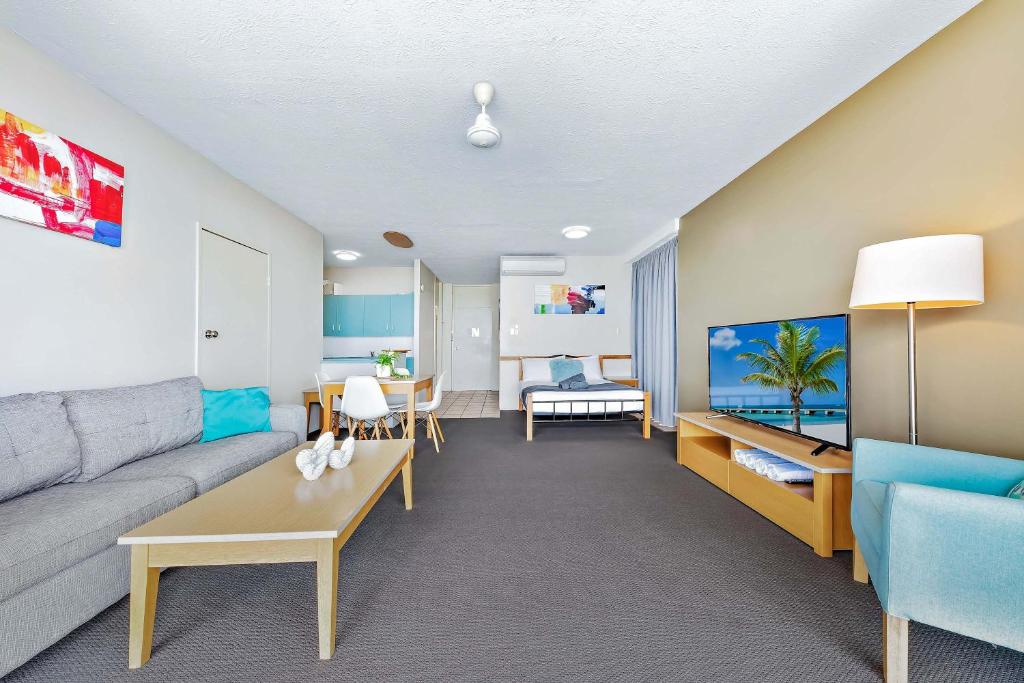 a living room with a couch and a table at Ocean View Apartment 14 in Airlie Beach