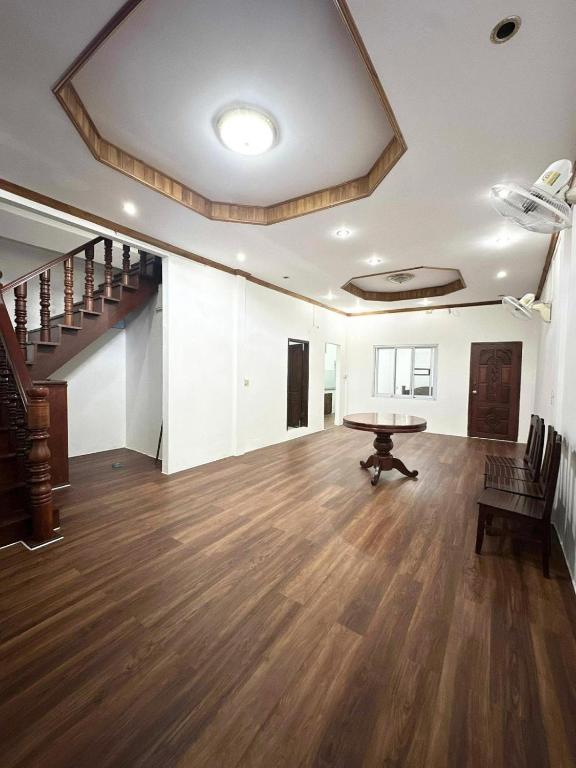 een grote woonkamer met een tafel en een trap bij Vientiane Semi detached house in Vientiane