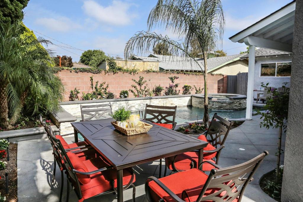 Un patio con mesa y sillas y una piscina. en Destination #35, en Anaheim