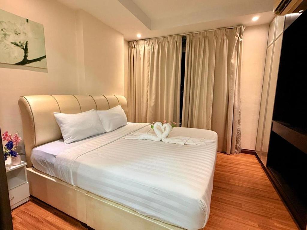 吉隆坡Taragon Puteri Bintang KLCC View Studio Apartment的一间卧室配有一张带两个天鹅的床