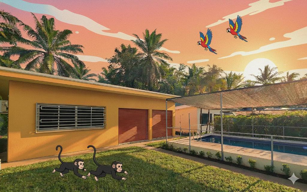 a painting of monkeys on the yard of a house at Pura Vida - Villa Lisa in Parrita