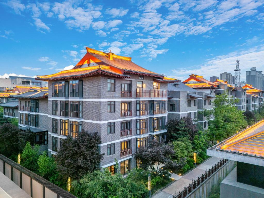 an apartment building with an orange roof at Xi'an Jinshengdi Hotel, Datang Everbright City, Big Wild Goose Pagoda Branch in Xi'an