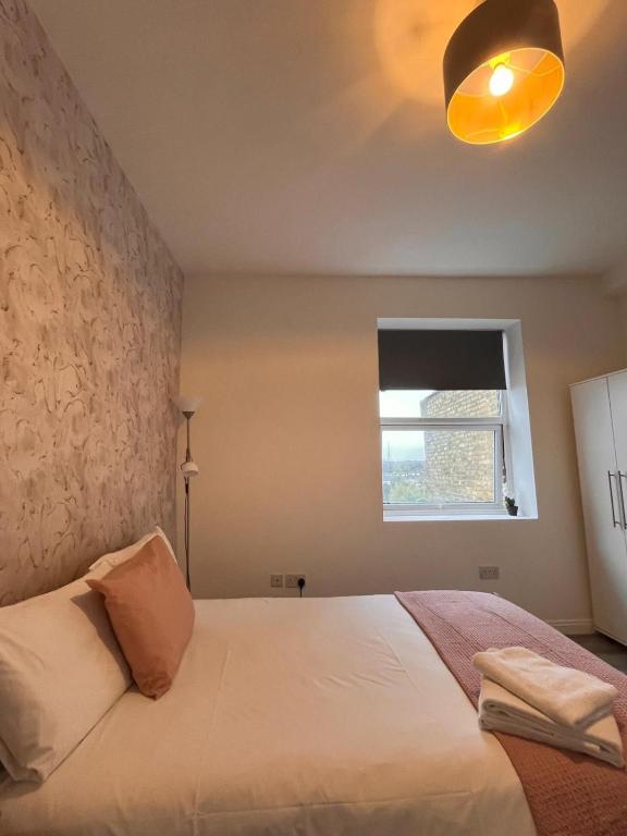 a bedroom with a white bed and a window at TLK Apartments & Hotel - Beckenham Junction in London