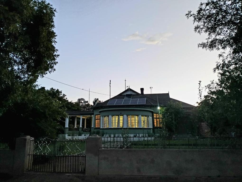 a house with a solar roof with a fence at Splash 9 in Trompsburg