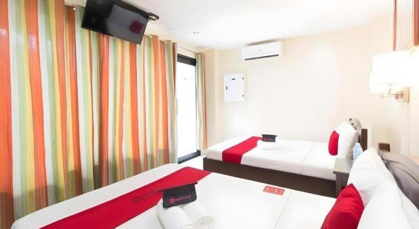 a hotel room with two beds and a television at Dino Residences in Daro