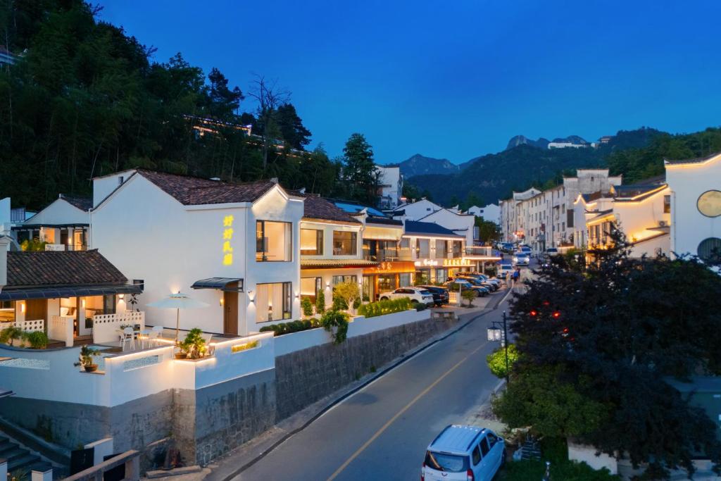 a view of a street in a town at night at Jiuhua Goodstay Inn in Chizhou