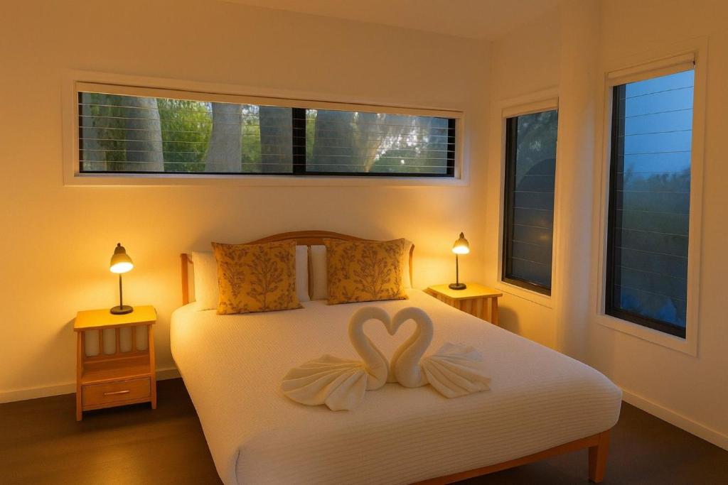 Hibiscus Haven 1BR getaway in Valla Beach في Valla Beach: غرفة نوم عليها سرير وديكور قلبي