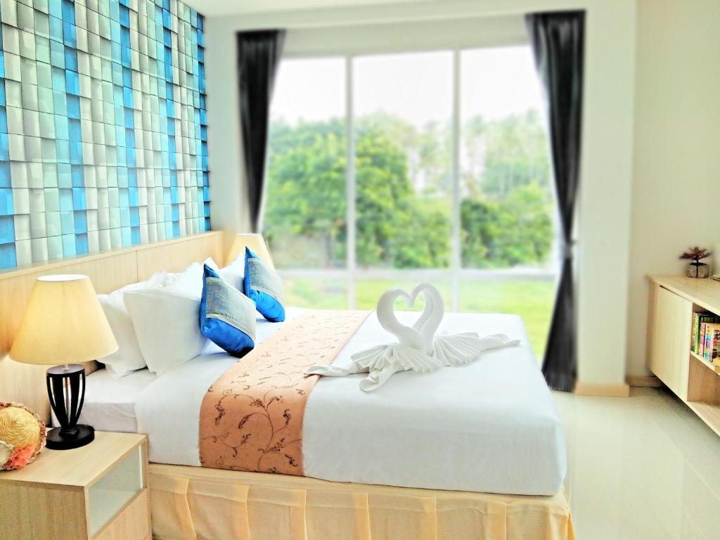 a bedroom with a bed with a swan decoration on it at The Wings Boutique Hotels Krabi Ko Lanta in Ko Lanta