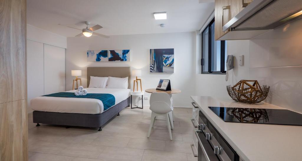 a hotel room with a bed and a kitchen at Annexe Apartments in Brisbane