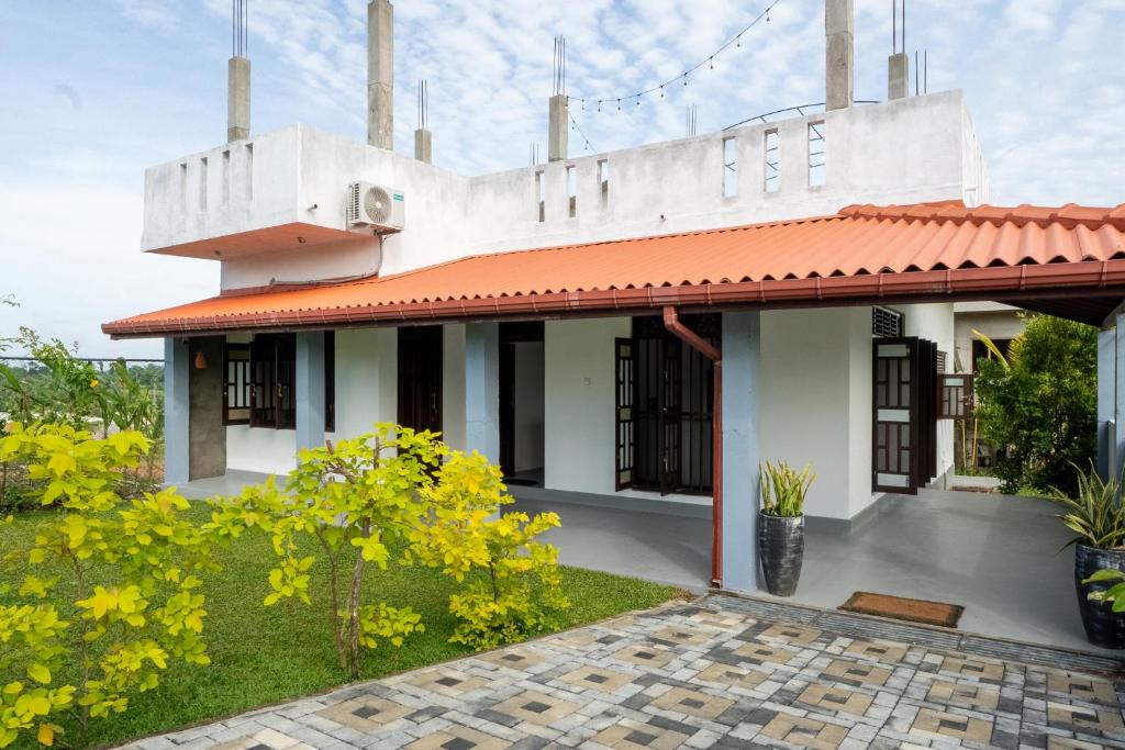 a house with a red roof at Villa Sky View Hikka in Hikkaduwa
