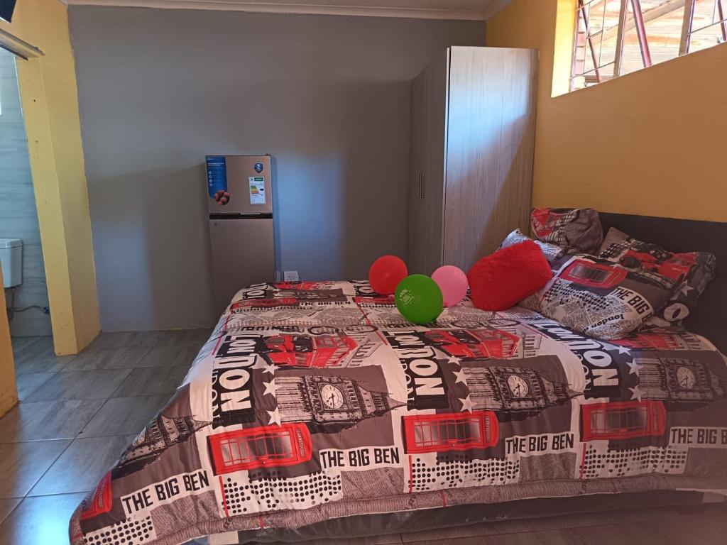 a bedroom with a bed with balloons on it at El Elyon Lodge in Pretoria