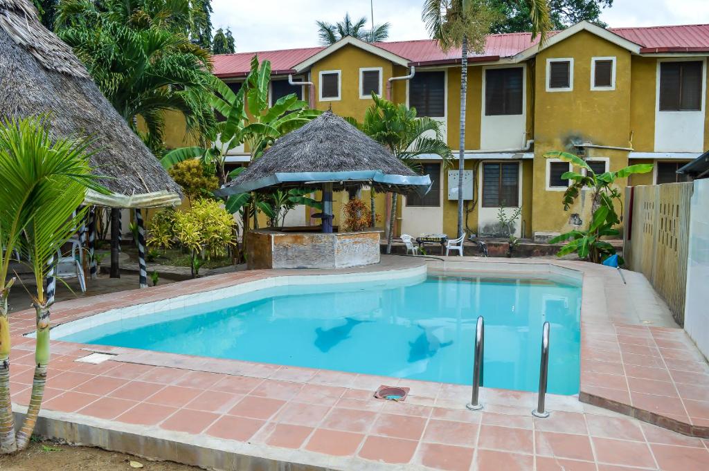 a swimming pool in front of a house at Ogalis K-coast Hotel in Mtwapa