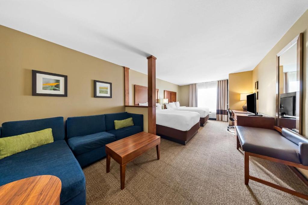 a hotel room with a couch and a bed at Comfort Inn & Suites West - Medical Center in Rochester
