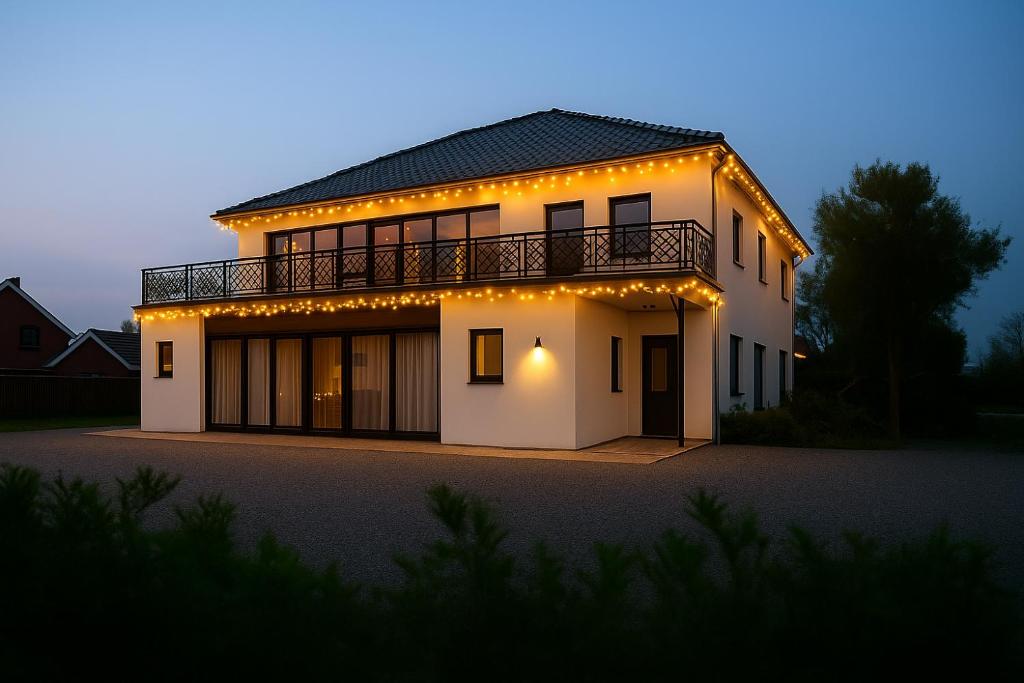 Une grande maison blanche éclairée la nuit dans l'établissement Boutique Hotel Villa Elise, à Winterswijk