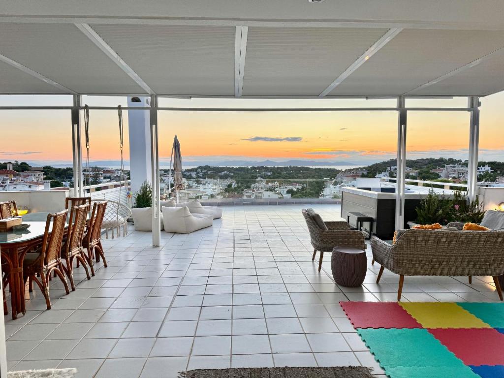a patio with a table and chairs and a piano at Villasonboard 3 Bed Penthouse Veranda Beach view jacuzzi Vouliagmeni Riviera in Athens