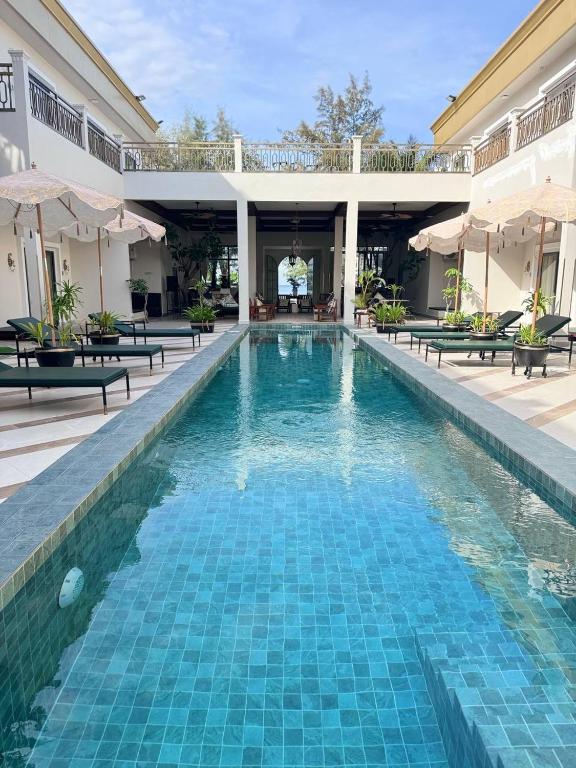 a swimming pool at a resort with a swimming poolvisorvisor at Vrest Hotel Otres Beach in Sihanoukville
